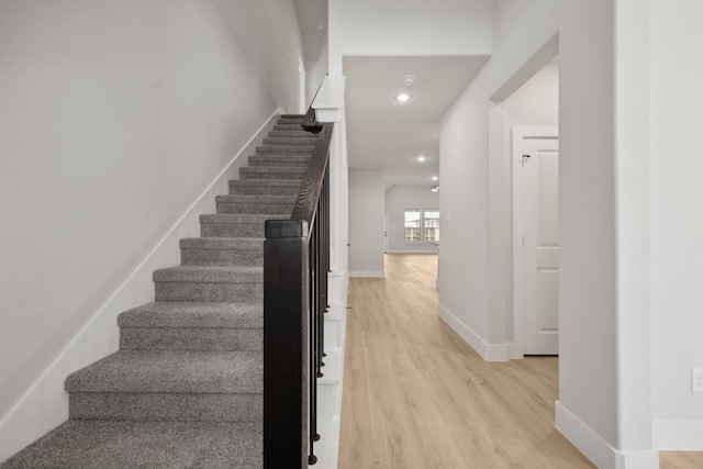 stairway with hardwood / wood-style flooring