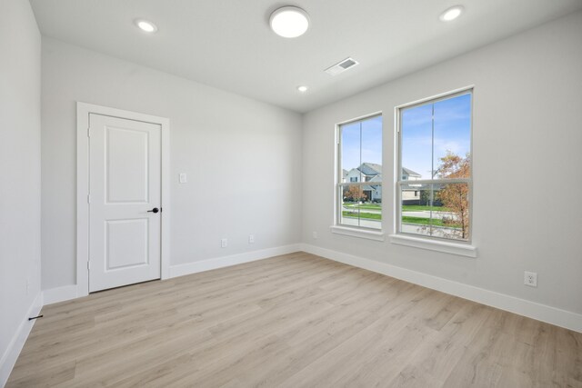 unfurnished room with light wood-type flooring