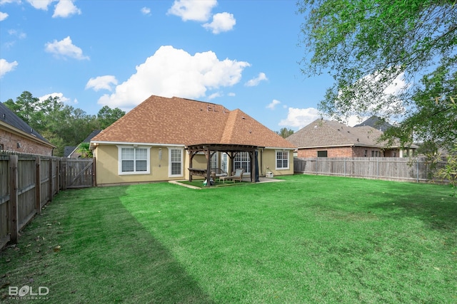 rear view of house featuring a pergola, a patio, and a lawn