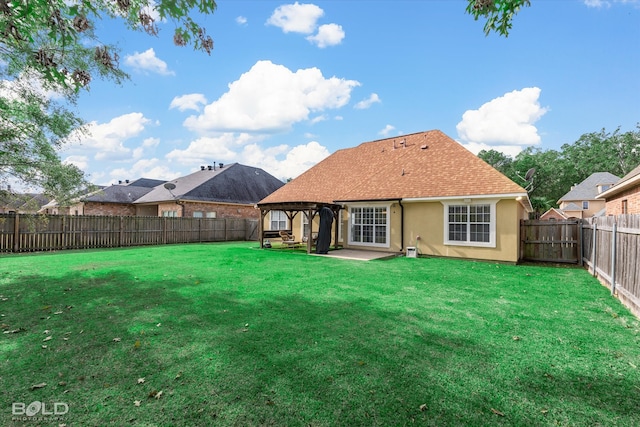 back of house featuring a yard