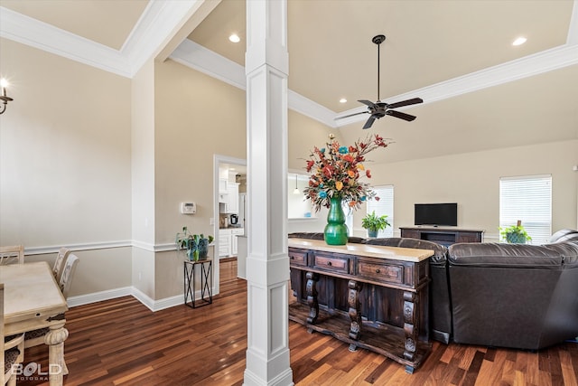 living room with decorative columns, dark hardwood / wood-style floors, and ornamental molding