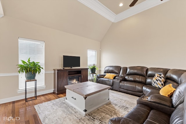 living room featuring light hardwood / wood-style flooring, a wealth of natural light, ornamental molding, and ceiling fan