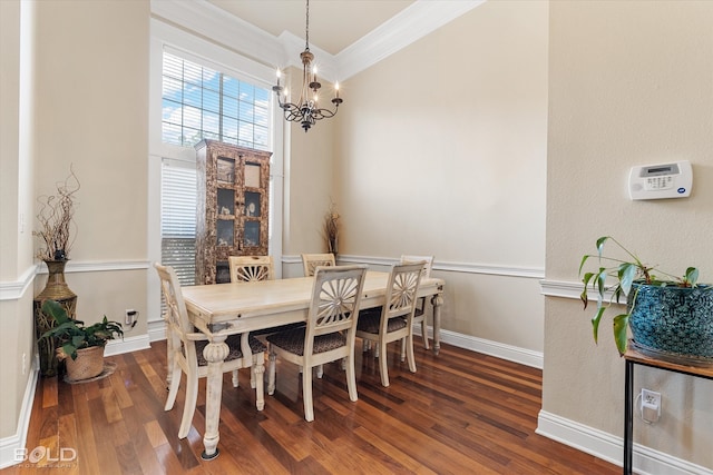 dining area featuring ornamental molding, dark wood-type flooring, and a chandelier