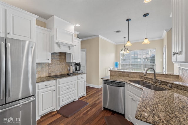 kitchen with white cabinets, appliances with stainless steel finishes, dark hardwood / wood-style floors, and dark stone countertops