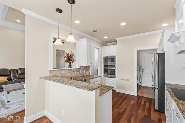 kitchen featuring kitchen peninsula, tasteful backsplash, stainless steel appliances, dark hardwood / wood-style floors, and white cabinetry