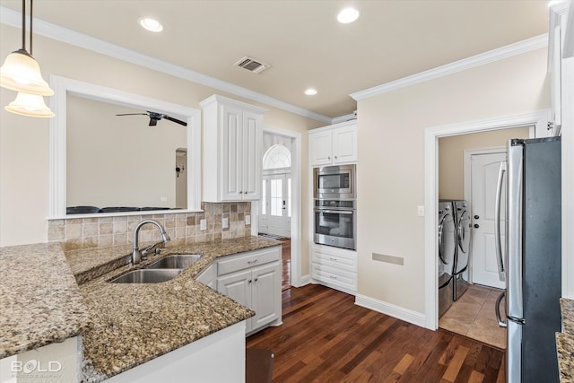 kitchen with white cabinets, dark hardwood / wood-style floors, sink, and stainless steel appliances