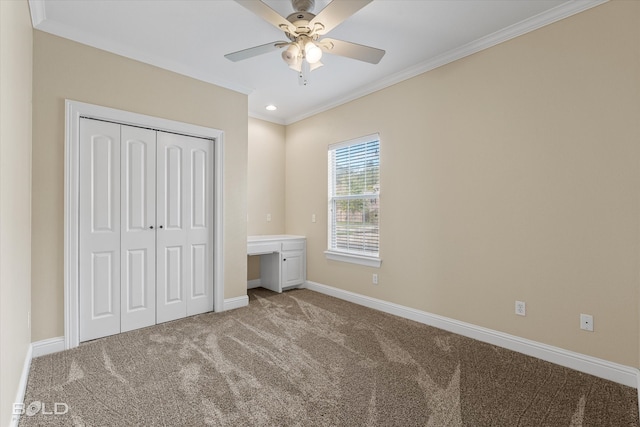 unfurnished bedroom with carpet, ceiling fan, ornamental molding, and a closet