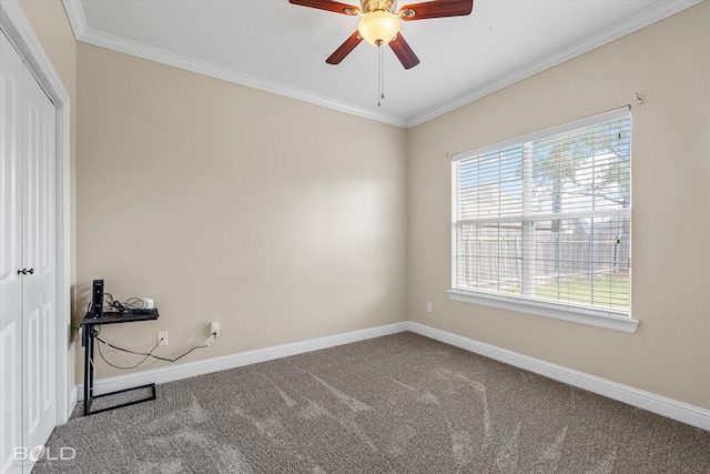 carpeted spare room with ceiling fan and ornamental molding