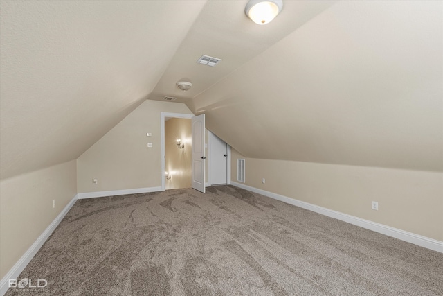 bonus room with carpet floors and lofted ceiling