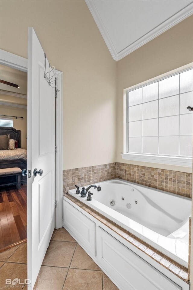 bathroom with a washtub, wood-type flooring, and crown molding