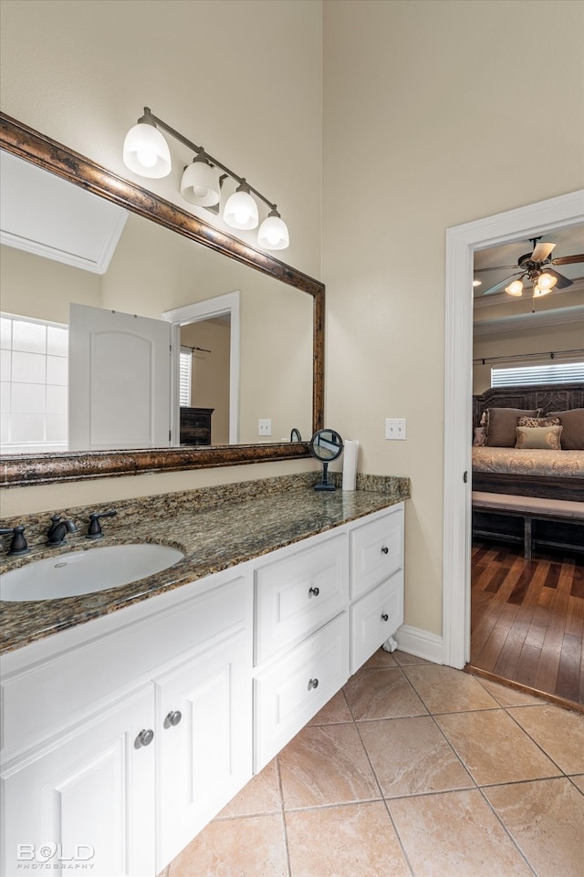 bathroom featuring hardwood / wood-style floors, vanity, ceiling fan, and crown molding