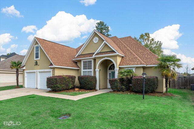 view of front of property featuring a front yard and a garage