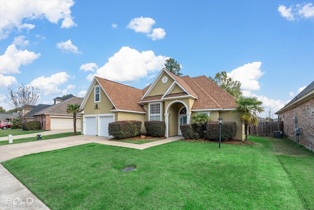 view of front facade featuring a garage, a front yard, and central AC