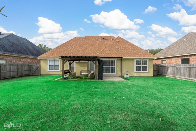 back of property with a pergola, a yard, and a patio