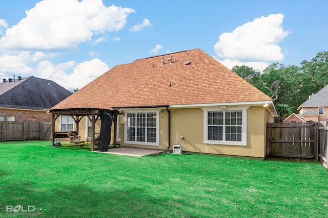 back of house featuring a lawn and a patio