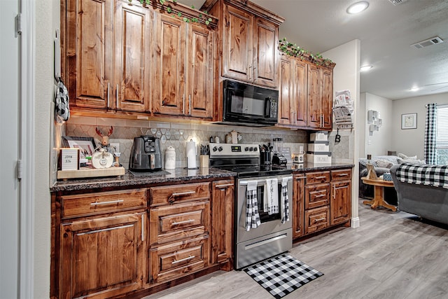 kitchen with light hardwood / wood-style floors, electric stove, backsplash, and dark stone counters