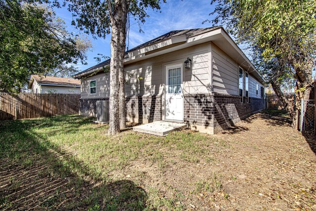 rear view of property with a yard