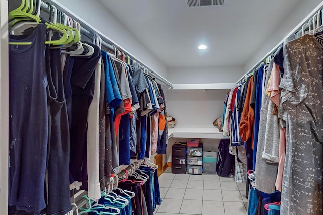 walk in closet with tile patterned floors