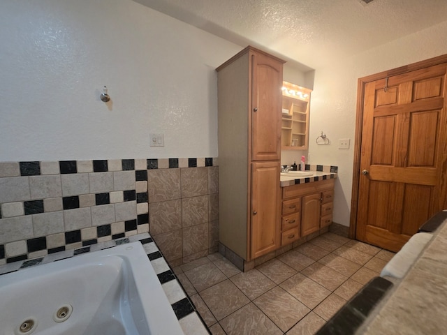 bathroom featuring tile patterned flooring, vanity, and a bathtub