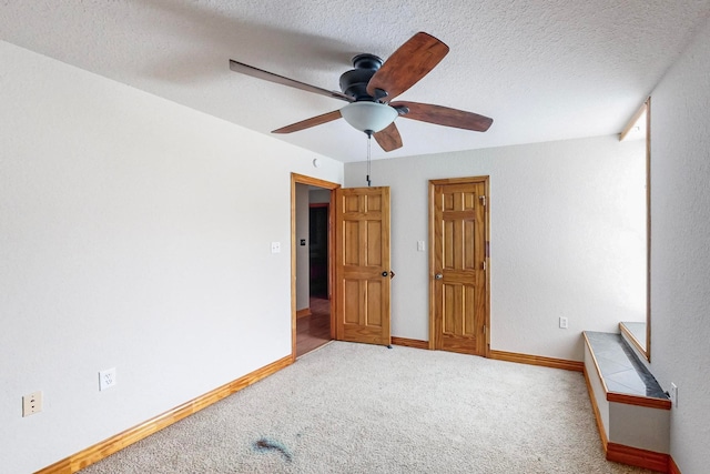 bedroom with carpet, ceiling fan, and a textured ceiling