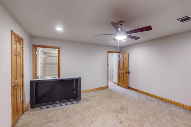 carpeted spare room featuring ceiling fan