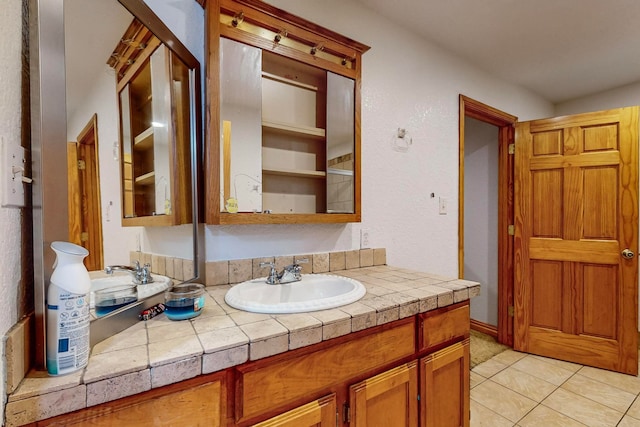 bathroom with tile patterned flooring and vanity