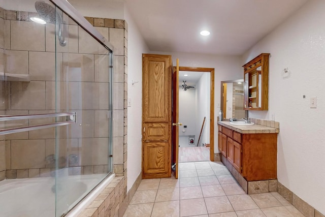 bathroom with tile patterned flooring, vanity, and combined bath / shower with glass door