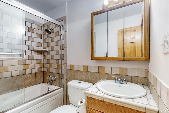 full bathroom featuring vanity, toilet, and enclosed tub / shower combo