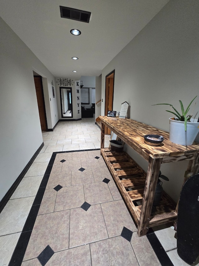 hall featuring light tile patterned floors