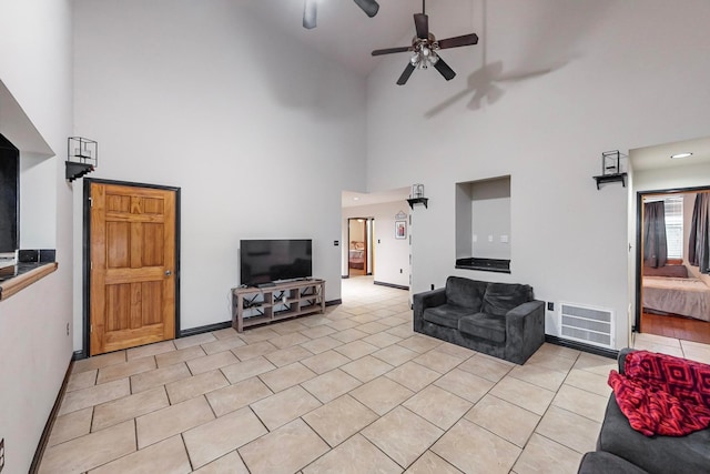 living room featuring ceiling fan and a towering ceiling