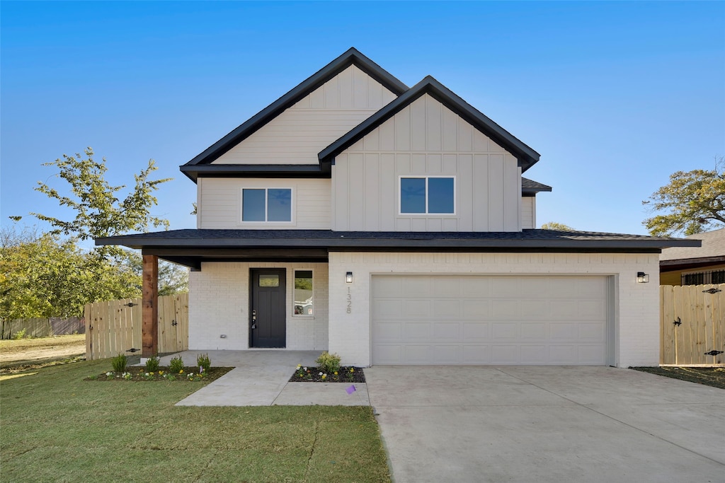 view of front of home featuring a garage and a front lawn