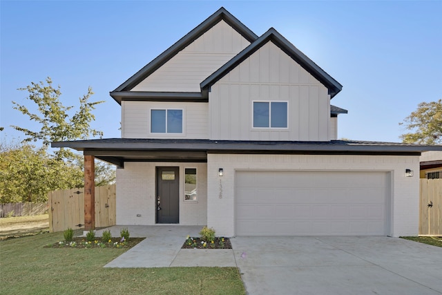 view of front of property with covered porch, a garage, and a front lawn