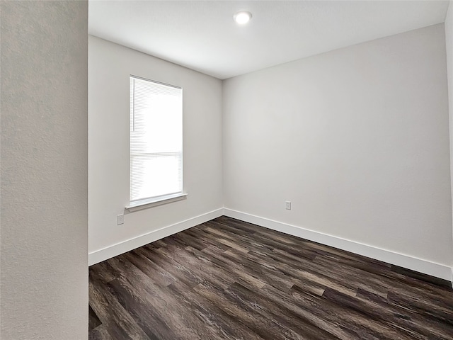 empty room with dark hardwood / wood-style floors