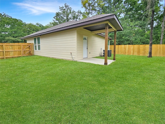 exterior space with a lawn, central AC unit, and a patio area