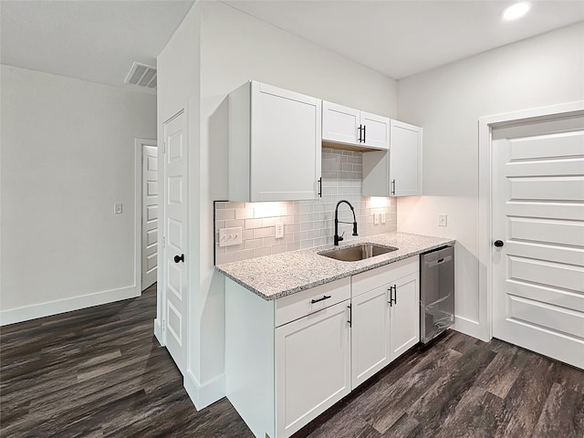 kitchen featuring dark wood-type flooring, sink, stainless steel dishwasher, light stone countertops, and white cabinetry