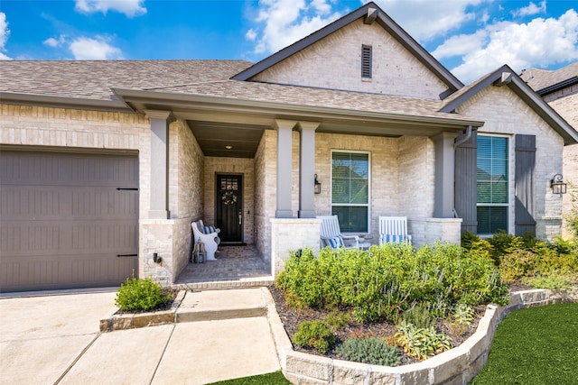 property entrance featuring covered porch and a garage