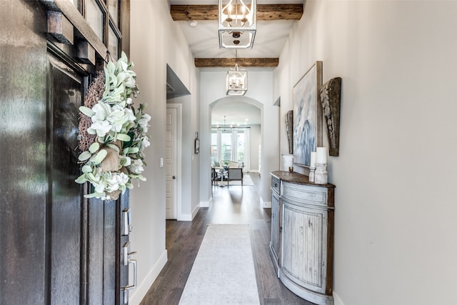 foyer with beamed ceiling and dark wood-type flooring