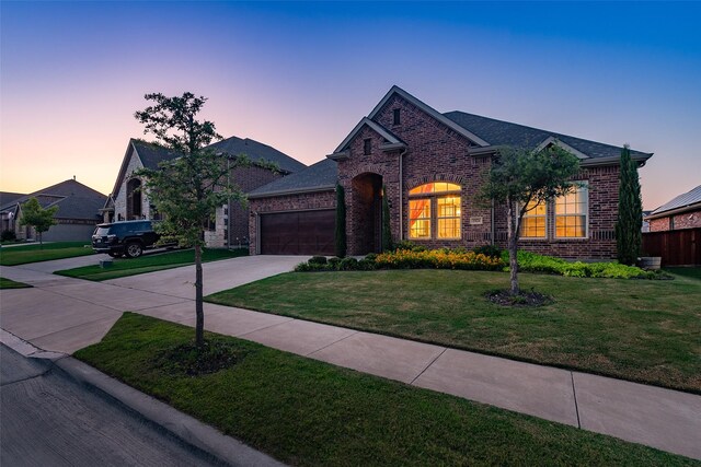 view of front of home featuring a garage and a front lawn