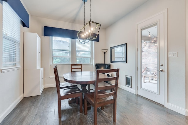 dining area featuring a chandelier and wood-type flooring