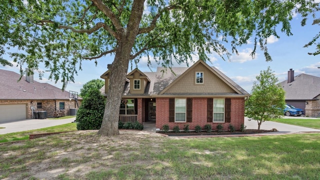 2045 Mason Pond Dr, Weatherford, TX 76085 - view of front facade with brick siding, central air condition unit, a front lawn, and a porch