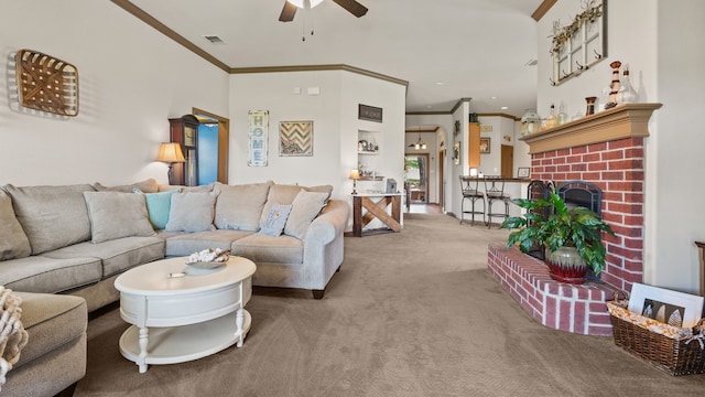 carpeted living room with a brick fireplace, ceiling fan, and ornamental molding