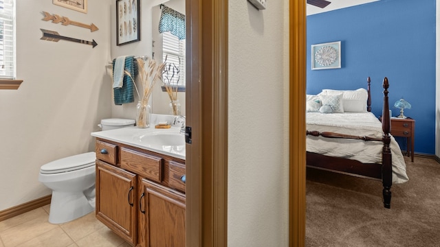 bathroom featuring tile patterned floors, vanity, and toilet