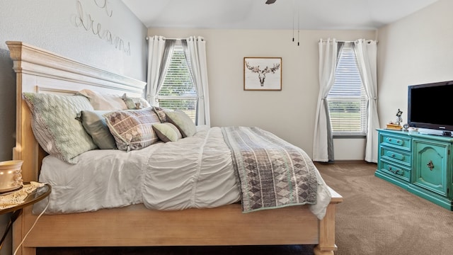 carpeted bedroom featuring ceiling fan and lofted ceiling