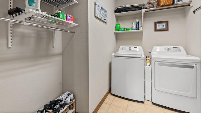 2045 Mason Pond Dr, Weatherford, TX 76085 - laundry room with washing machine and dryer and light tile patterned floors