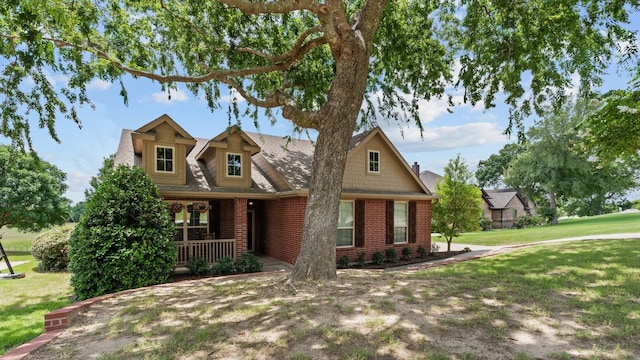 craftsman inspired home with covered porch and a front yard