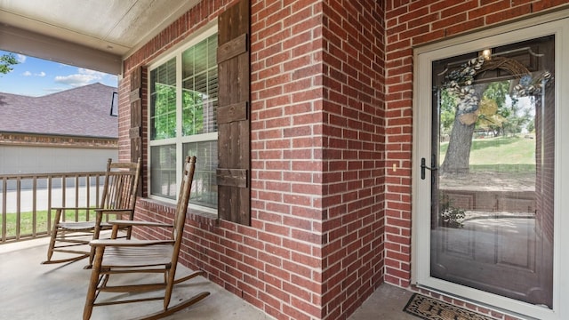 2045 Mason Pond Dr, Weatherford, TX 76085 - view of exterior entry featuring a porch and brick siding