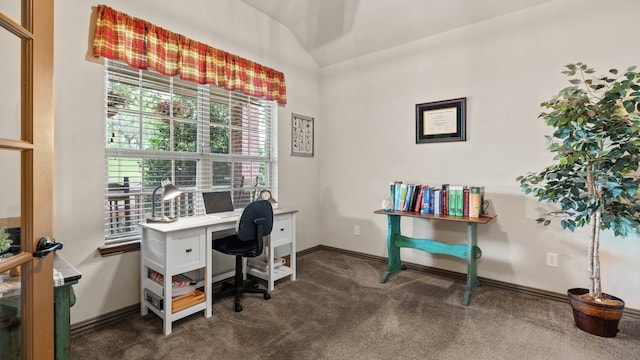 office space featuring vaulted ceiling and dark carpet