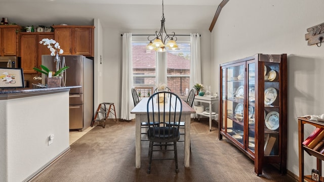 dining space with a chandelier and light colored carpet