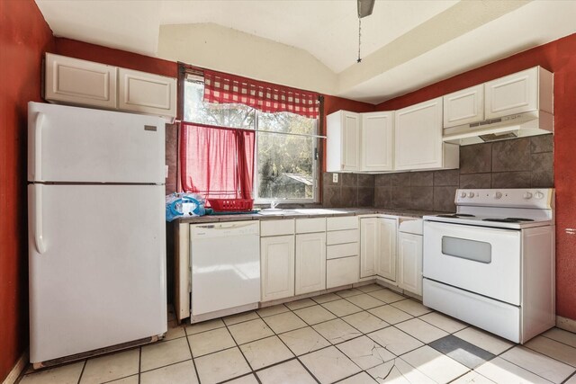 kitchen featuring lofted ceiling, white appliances, decorative backsplash, light tile patterned flooring, and white cabinetry