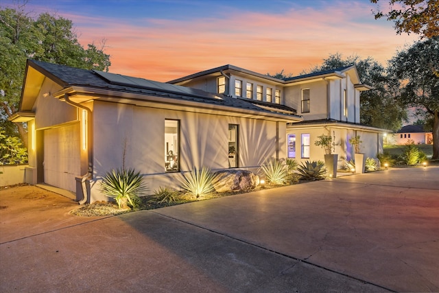 view of front of house with solar panels and a garage